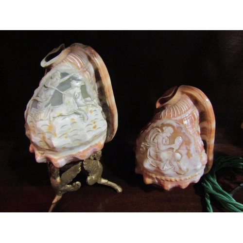 4063 - An ornately carved cameo conch shell table lamp and two shades