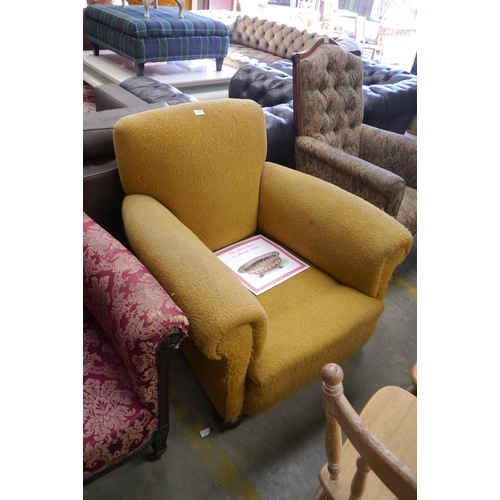 2561 - A 1920's yellow deep seated club chair on bun feet