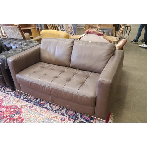 2568 - A brown leather sofa with tubular steel frame