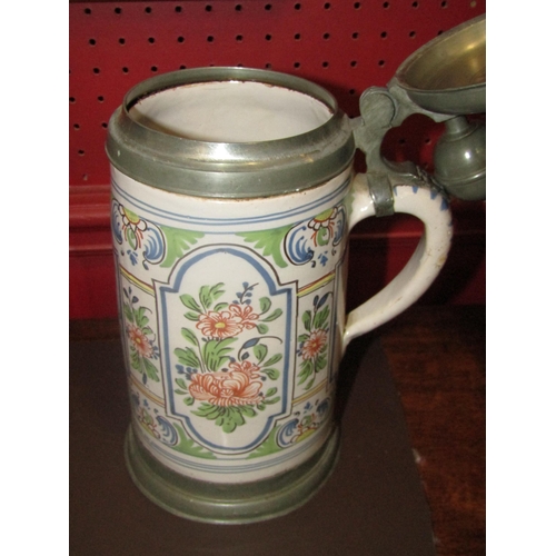 4031 - A German Delft and pewter tankard, 28cm tall