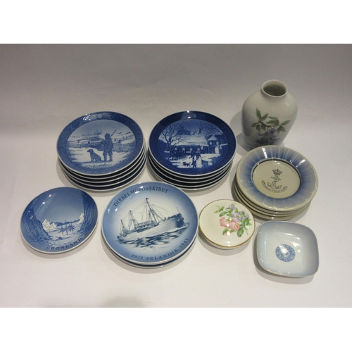 4486 - A collection of Royal Copenhagen Christmas plates, ashtrays, vase, etc.