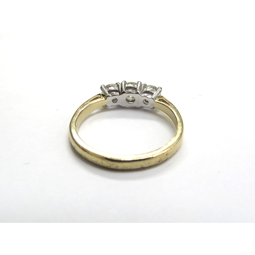 6002 - An 18ct gold three stone diamond ring, 0.83ct total, G/SI. Size 3.9g