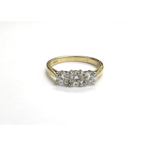 6002 - An 18ct gold three stone diamond ring, 0.83ct total, G/SI. Size 3.9g