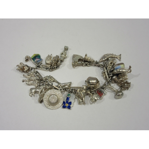 1328 - A silver charm bracelet hung with various charms