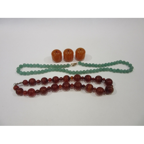 1336 - A cornelian bead necklace, three amber beads and a green quartz necklace