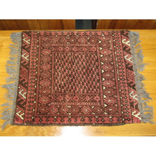 1137 - A small red and black Persian rug, 60cm x 54cm