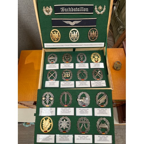 8215 - Two cases of mixed West German insignia including Beret badges