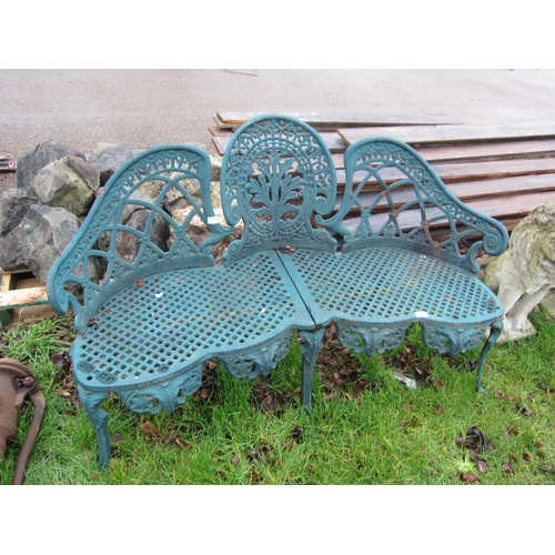 9027 - A decorative cast iron shaped garden bench, back loose