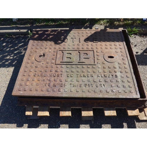 9017 - A BP cast manhole cover with frame, 87cm x 70cm