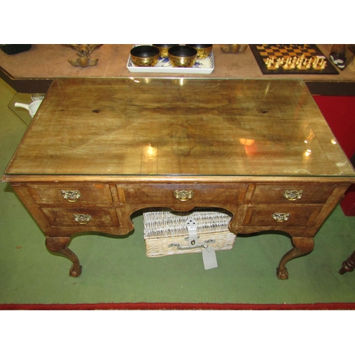 4003 - A walnut Queen Anne style desk, frieze drawer flanked by banks of two short drawers on cabriole legs... 
