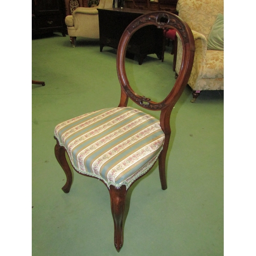 4050 - A pair of Victorian carved walnut spoon back chairs, the Serpentine front seat on French cabriole fo... 