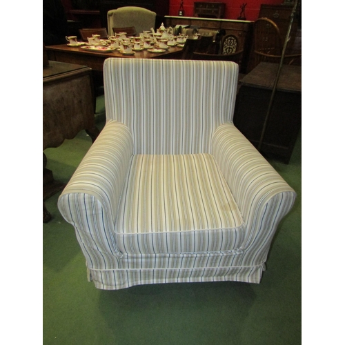 4052 - A Victorian style armchair with striped loose cover, the scroll arms over square tapering feet
