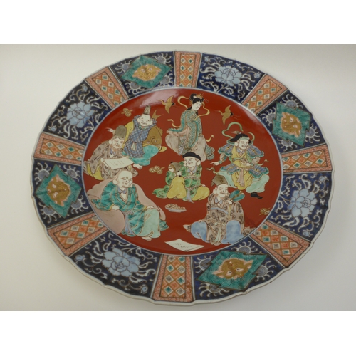 4018 - A pair of 19th Century Chinese ceramic chargers of large proportions. A panelled border surrounding ... 