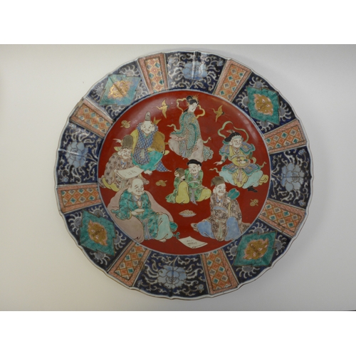 4018 - A pair of 19th Century Chinese ceramic chargers of large proportions. A panelled border surrounding ... 