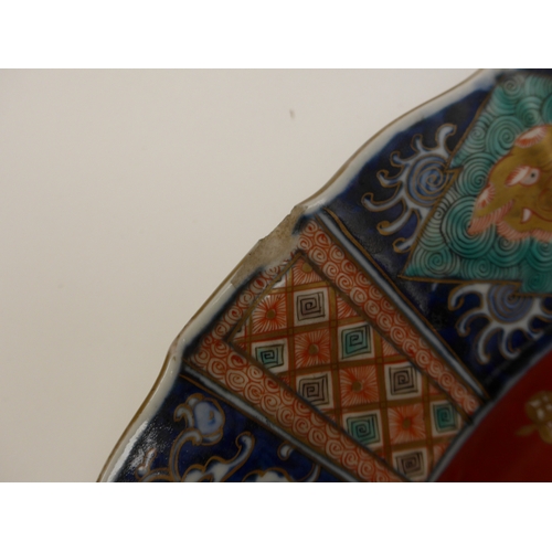 4018 - A pair of 19th Century Chinese ceramic chargers of large proportions. A panelled border surrounding ... 