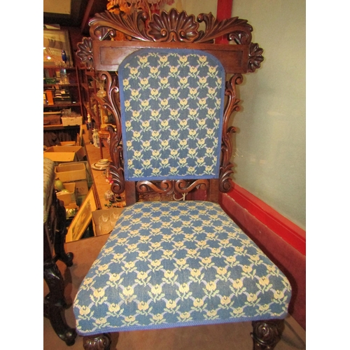 4013 - An early Victorian carved walnut 'T' shaped ornate back rest chair on carved and turned fore legs