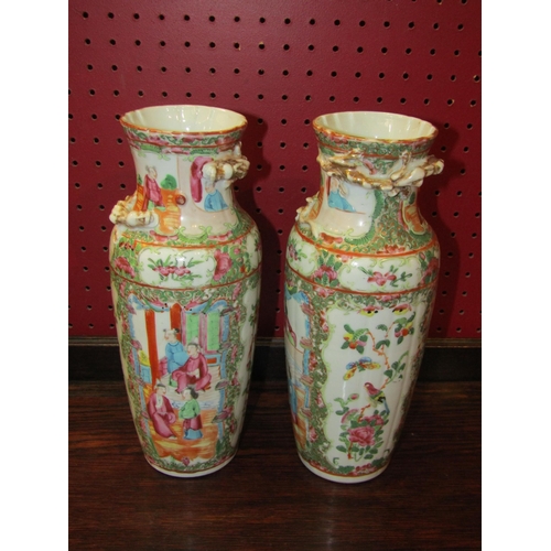 4055 - A pair of Chinese vases with panels depicting figural scenes, birds and flowers. 26cm height