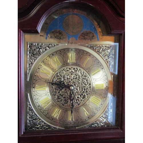 4025 - An Emperor mahogany longcase clock with two weights and a pendulum, atlas detail to face