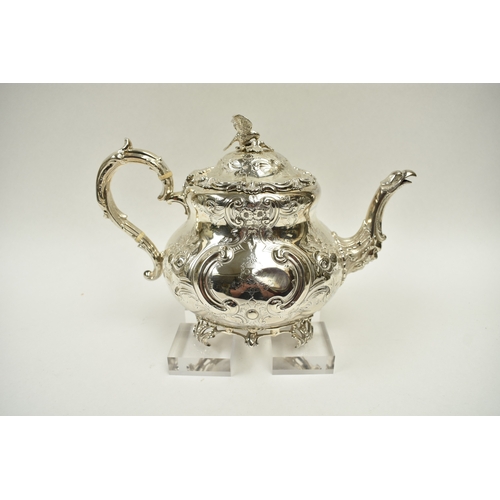 8009 - A Martin, Hall & Co. Victorian silver four piece tea set of highly ornate form.  Both pots lids are ... 