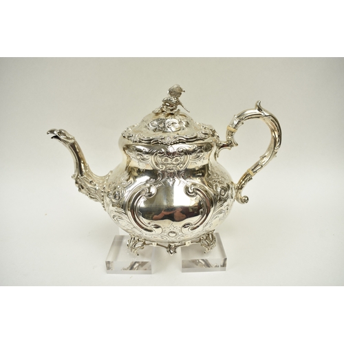 8009 - A Martin, Hall & Co. Victorian silver four piece tea set of highly ornate form.  Both pots lids are ... 