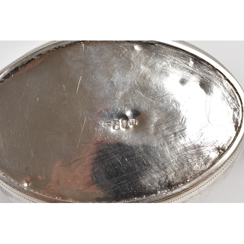 8027 - A Richard Sawyer, Dublin, silver oval teapot with monogrammed and crested cartouches, 1804, together... 