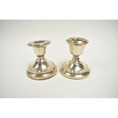 8046 - Two similar S.J. Rose & Son filled silver squat form candlesticks.  Noticeable dent to base edge of ... 
