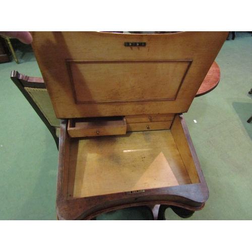 4064 - Circa 1850, a burr walnut Davenport the brass gallery over a fitted maple interior over four drawers... 