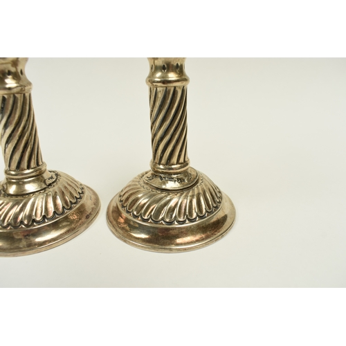 8018 - A pair of Victorian Walker & Hall silver taper candlesticks, wrythen detail, weighted bases, damage ... 