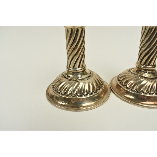 8018 - A pair of Victorian Walker & Hall silver taper candlesticks, wrythen detail, weighted bases, damage ... 