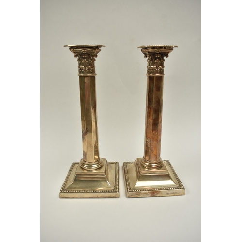 8012 - A pair of late Victorian Reid & Sons silver tall facet Corinthian column candlesticks on cushioned b... 