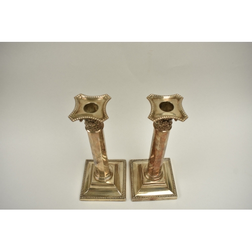 8012 - A pair of late Victorian Reid & Sons silver tall facet Corinthian column candlesticks on cushioned b... 