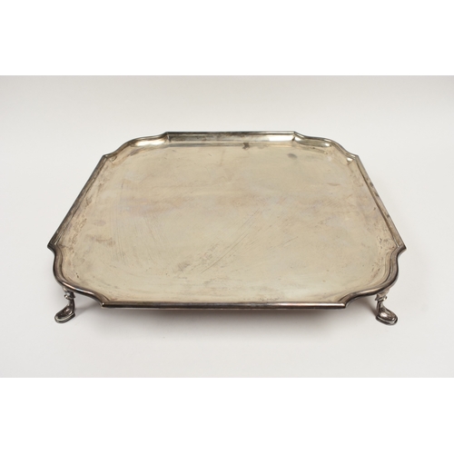 8030 - A Hawksworth, Eyre & Co Ltd silver square form salver raised on four feet with shaped corners, Londo... 