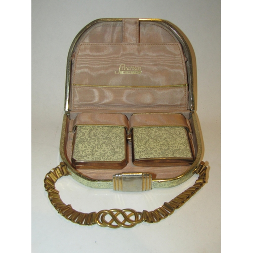 A Stratton compact in the form of a lady's handbag with powder compact ...