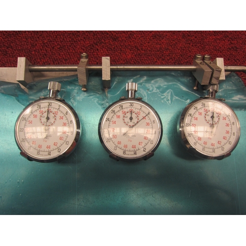 7064 - An aluminium racing clip board with three Precista stop watches. This item was acquired by the vendo... 