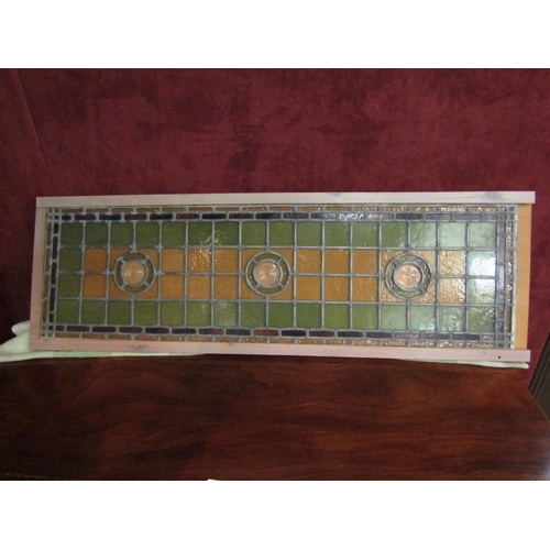 A leaded stained glass window panel with three bullseye roundels, red ...