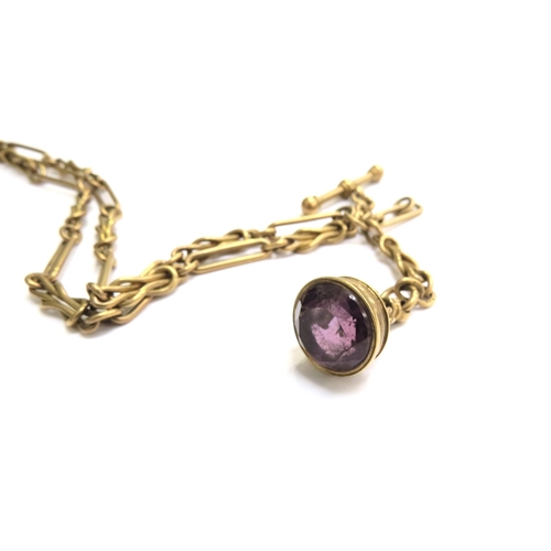 7243 - An 18ct gold watch chain with T-bar, each link stamped 18ct, hung with an amethyst fob, 27cm long, 3... 