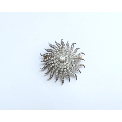 7039 - A Victorian diamond encrusted brooch of a sun burst, the centre stone 0.50ct framed by three circles... 