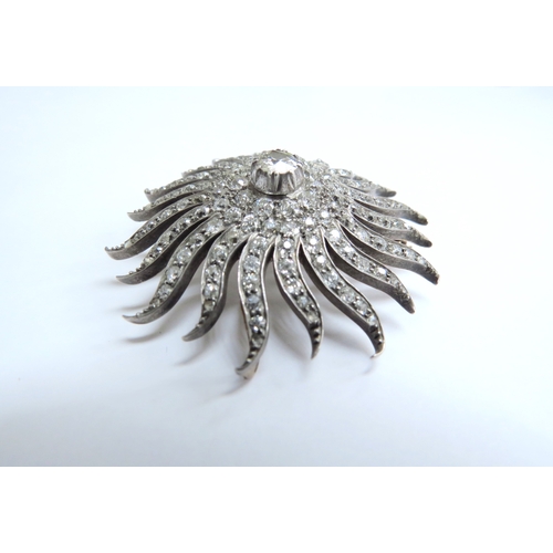 7039 - A Victorian diamond encrusted brooch of a sun burst, the centre stone 0.50ct framed by three circles... 