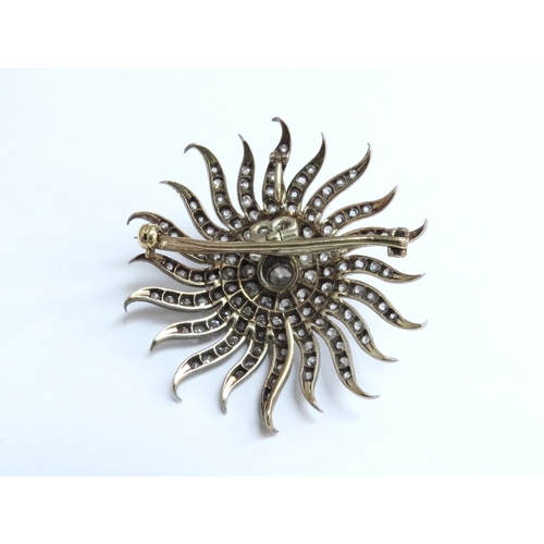 7039 - A Victorian diamond encrusted brooch of a sun burst, the centre stone 0.50ct framed by three circles... 