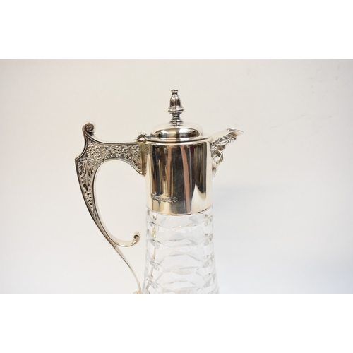 8007 - A Camelot Silver ltd silver necked claret  jug, Sheffield 2000, with crystal glass body retailed by ... 