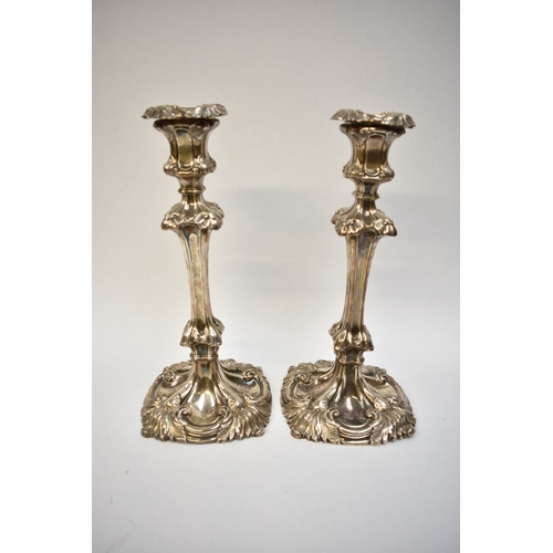 8002 - A pair of Henry Wilkinson & Co silver candlesticks, Rococo style with scrolled foliate relief, Sheff... 