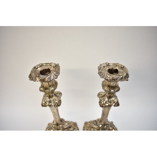 8002 - A pair of Henry Wilkinson & Co silver candlesticks, Rococo style with scrolled foliate relief, Sheff... 