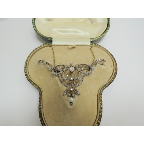 7034 - A diamond encrusted brooch/pendant in yellow and white metal with a single pearl to point, unmarked,... 