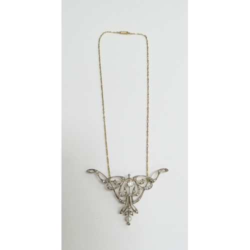 7034 - A diamond encrusted brooch/pendant in yellow and white metal with a single pearl to point, unmarked,... 