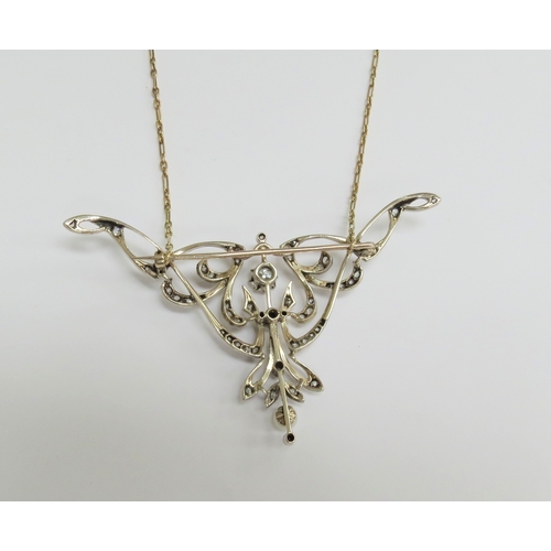 7034 - A diamond encrusted brooch/pendant in yellow and white metal with a single pearl to point, unmarked,... 