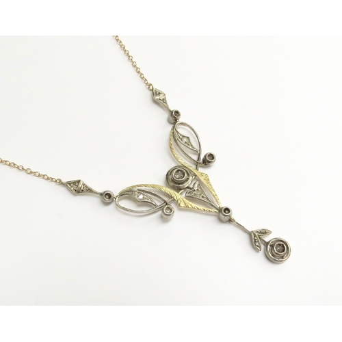 7001 - A yellow gold longuard necklace with a rose cut diamond set pendant of Art Nouveau style in yellow a... 