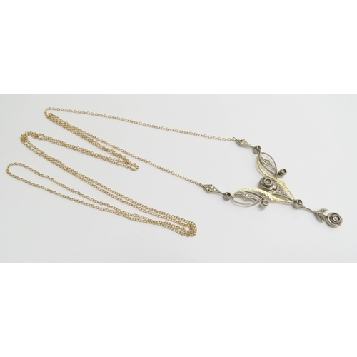 7001 - A yellow gold longuard necklace with a rose cut diamond set pendant of Art Nouveau style in yellow a... 