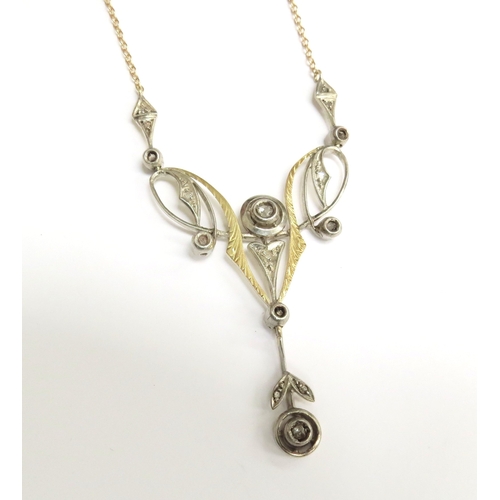 7001 - A yellow gold longuard necklace with a rose cut diamond set pendant of Art Nouveau style in yellow a... 