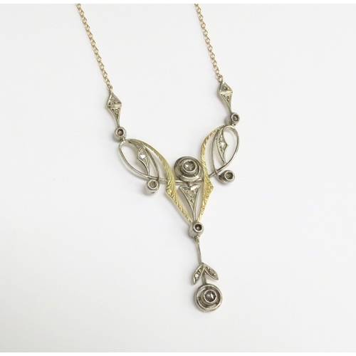 7001 - A yellow gold longuard necklace with a rose cut diamond set pendant of Art Nouveau style in yellow a... 