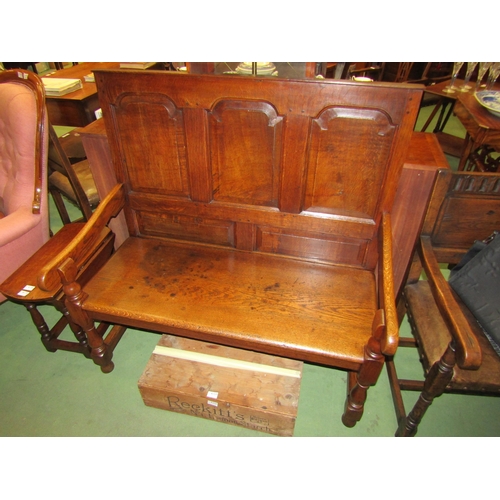 4176 - A 17th Century revival oak three panel back hall settle the scroll arms on turned supports united by... 